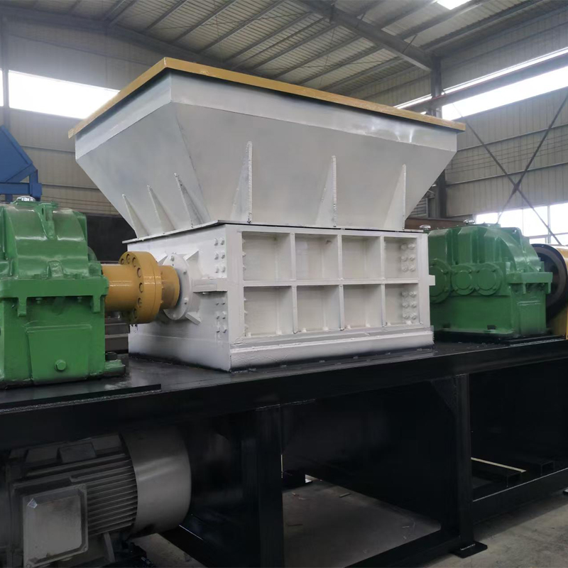 Double Shaft Shredder in operation, gripping and tearing metal scrap in the cutting chamber